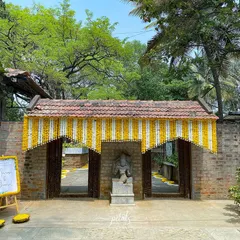 The entrance to Angana the Courtyard is adorned with a simple yet elegant floral toran, welcoming guests to a day of celebration.