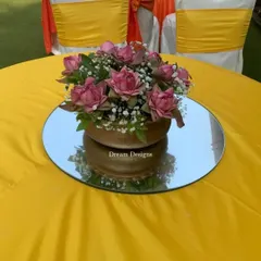 A cheerful yellow tablecloth sets the stage for a lotus centerpiece. I use bold, solid colors in my Mehndi designs to create a vibrant and energetic atmosphere.