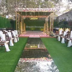 A truly glamorous ceremony setup featuring a floral mandap with a dazzling mirrored aisle. The reflection of the sky and the decor creates a spectacular visual, making the bridal entrance a breathtaking moment.