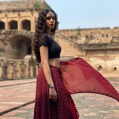 This is from the music video for 'Jogan', where I designed a dark, moody boho look. I paired a black sequined blouse with a deep red lehenga and layered oxidized silver jewellery to create a powerful and mystical character. This kind of detailed character styling is a key part of my process.