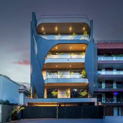 The Lotus Villa at night, where lighting accentuates the organic curves and gives each level its own identity. The design softens the structure, making the villa stand tall yet feel seamlessly integrated with its surroundings.
