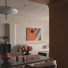 From this angle, you can see how the dining area opens up to the living room. The consistent use of natural materials and a neutral palette creates a cohesive and harmonious home environment.