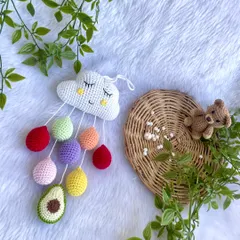 The cloud mobile displayed with a little teddy bear to show its playful, gentle vibe.