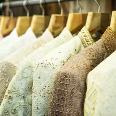 A look at our collection rack, showcasing a variety of sherwanis and Indo-Western jackets. Each piece is a testament to our commitment to craftsmanship, with diverse embroidery, fabrics, and colors ready for our clients.