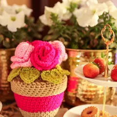 A sweet bunch of Rosie Posies in a crochet pot. This little floral arrangement is perfect for a tea party tablescape or as a permanent bouquet on a side table.