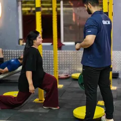 We provide focused, one-on-one training for our female clients. Here, a coach ensures perfect lunge form to build lower body strength and stability.