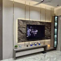 A TV unit can be the statement piece of your living room. For this space, I used a combination of a dark marble-finish panel, soft backlighting, and sleek metal inlays to create a modern and luxurious entertainment center.