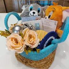 For the sibling bond that's just like Tom and Jerry. This cute Rakhi hamper features Tom and Jerry plush toys in a woven basket, complete with an evil-eye dreamcatcher and a greeting card.