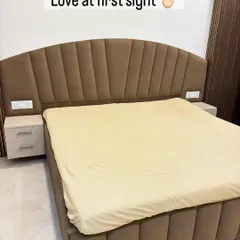 This fully upholstered bed features a beautiful arched headboard with channel tufting. The warm brown fabric and matching floating side tables create a soft and inviting look.