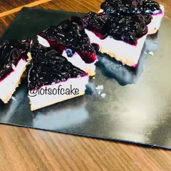 My blueberry cheesecake, sliced and ready to be served. The contrast between the dark blueberry topping and the white creamy filling is just beautiful.