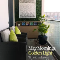 May mornings and golden light. This balcony is designed to be a pure delight, with comfortable wicker armchairs, vibrant green cushions, and a vertical garden wall that adds life and privacy.