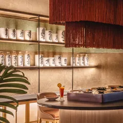 Detail is everything. At the Lucky Chan sushi bar, we layered a cascading tassel light fixture over traditional Japanese scripted pots to create a corner that feels both whimsical and grounded, blending modern aesthetics with cultural authenticity.