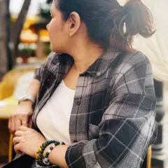 Capturing the details of a K-drama inspired casual look. The focus here is on texture and layering, with a soft plaid shirt and simple accessories that create a comfortable yet put-together style.