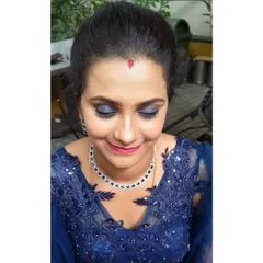 A detailed look at the party makeup for the client in the blue gown. The deep blue smokey eyeshadow is blended perfectly to create a glamorous effect, paired with a soft pink lip to balance the look.