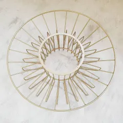 The completed metal base of the Bloom table after fabrication and finishing. This top-down view shows the radial symmetry of the design before the wooden top is fitted.