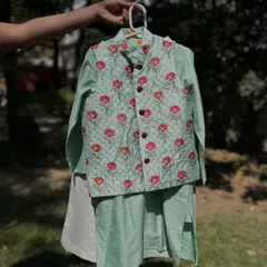 Here is the same quilted Nehru jacket set in a refreshing mint green. The floral print adds a touch of elegance, making it a perfect choice for summer weddings and celebrations.