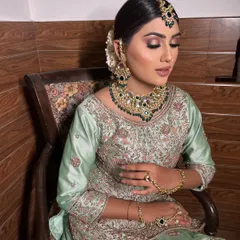 A full view of the subtle Nikkah look. The elegant bun hairstyle and statement jewelry complete the look perfectly. Bridal makeup like this starts from ₹9999 at our studio.