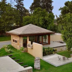 The garden pavilion at C Farm is a study in simplicity and form. Nestled into the landscape with stone and plaster walls, it provides a secluded, sheltered space for relaxation with a direct connection to the surrounding greenery.