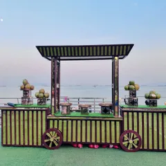 Our charming coconut water cart, set against a beautiful seaside backdrop. We serve fresh coconut water straight from the source, a healthy and refreshing drink option.