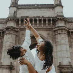 A dynamic and happy moment captured in front of the Gateway of India. The pose is full of life and joy, perfectly representing their beautiful connection.