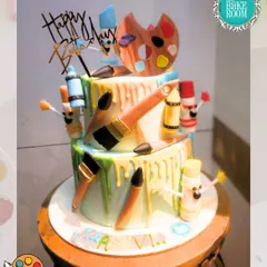 A cake that is a true work of art, for an artist. This two-tiered cake is decorated with edible paintbrushes, a color palette, and colorful drips to look like a creative masterpiece.