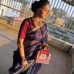 Glowing is a choice. This messy bun hairstyle is perfect for a modern, elegant look. It's paired with a sheer saree for a sophisticated party style.