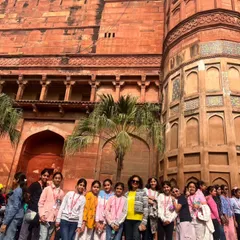 Students and teachers pose in front of the historic Agra Fort. Our educational trips offer deep insights into Mughal architecture and India's rich history.
