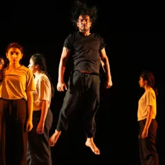 A dancer is captured mid-air, showcasing the explosive energy of our contemporary choreography in "TATSAMA TADBHAVA." This production combines physical theatre with traditional Indian dance to tell a compelling story.