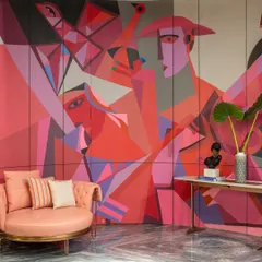 A vibrant, cubist-inspired mural in shades of pink and red, adding a bold statement to a residential space.