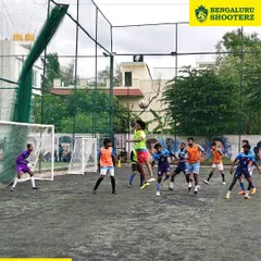 It's all about game-time decisions. Here, our young footballers compete for an aerial ball during a practice match, a crucial skill we develop through constant heading sessions and match simulations.
