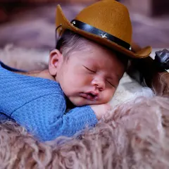 Our little cowboy, dreaming of the wild west. The tiny hat adds so much character to this adorable, sleepy portrait.