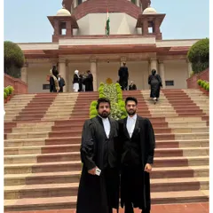 Standing with a colleague outside the Supreme Court. I believe being a lawyer is a public trust, and I am committed to upholding the rights and liberties guaranteed by our Constitution.
