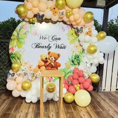 A sweet "We Can Bearly Wait" teddy bear themed baby shower with a custom backdrop and a pastel balloon arch.