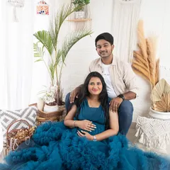 A lovely couple portrait in the lifestyle corner of my studio. The mom-to-be looks stunning in a blue ruffled gown, perfectly complementing the natural, earthy tones of the boho decor.