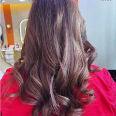 A beautiful example of soft, multi-tonal brown hair styled into gentle waves. This look is both sophisticated and modern.