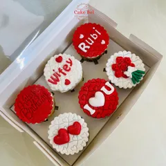 A box of six custom cupcakes designed to say "I love you." This romantic set features detailed fondant work with messages like "Wifey," "I ❤️ U," a bouquet of roses, and personalized names, making it a perfect anniversary or birthday gift.