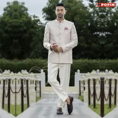 For a daytime event, I suggest a lighter option like this off-white printed Jodhpuri suit. Paired with white trousers, it's a fresh and elegant choice that combines traditional tailoring with a contemporary pattern.