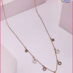 A versatile essential for every collection. This sleek rose gold chain is adorned with alternating black and white diamond-studded circles, offering a modern and understated appeal.