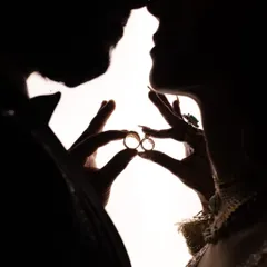 A creative silhouette shot of the couple with their engagement rings. This artistic approach focuses on the symbol of their commitment in a unique and memorable way.