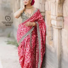Another elegant pose in the pink Navvari saree, showcasing its rich fabric and traditional drape.