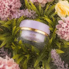 A creative and evocative shot of a product jar nestled among flowers, viewed through a water-beaded glass. This technique adds texture and a sense of freshness, as if the product is a natural treasure discovered in a misty garden.