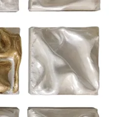 A detail of one of the all-silver dancers. Their surfaces swirl in graceful, unified steps, blending into a seamless choreography of light and shadow.
