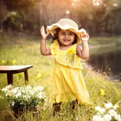 A little ray of sunshine in a field of flowers. This toddler portrait, taken during the golden hour, captures the pure joy of a child playing outdoors.
