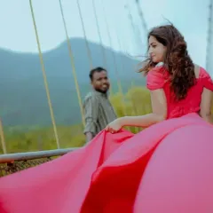 A candid shot on a bridge, where the long trail of the pink gown flows behind the client, adding a sense of movement and romance.