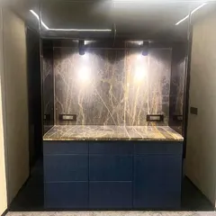 I designed this exclusive bar and storage unit for a Chairman's Boardroom to be both stylish and discreet. The dark marble backsplash with gold veining provides a luxurious focal point, while the custom cabinetry offers seamless storage for meetings and corporate events.