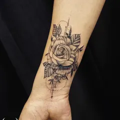A detailed rose tattoo designed specifically to cover a scar on the wrist. We can strategically place designs to work with and conceal skin imperfections.
