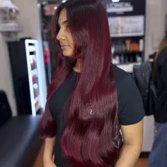 A side view of the cherry red magic. The color is rich and consistent from root to tip, which is the hallmark of a professional color application.