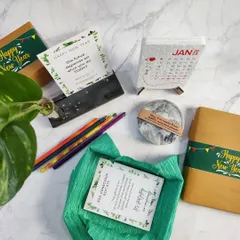 Our eco-conscious gift kit is thoughtfully curated for a sustainable new year. It includes a variety of our recycled products, from a photo holder to coasters and a plantable calendar.