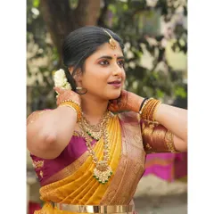Dressed in a beautiful yellow and pink silk saree. I love the richness of traditional Indian textiles and jewelry.
