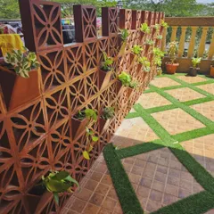 For this gallery space, I designed and installed a custom terracotta jali wall that doubles as a vertical planter. This adds an earthy, traditional touch while creating a unique green feature wall for the balcony.
